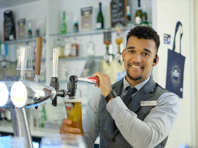 Staff member pouring a drink